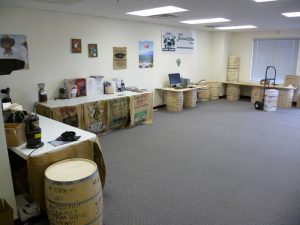 Tables with coffee roasters, ginders, and brewers in an office space