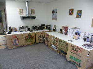 Burman Traders coffee testing lab; with various roasters, ginders, and brewers on tables