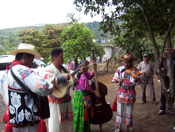 Local Mexican musicians in bright traditional outfits