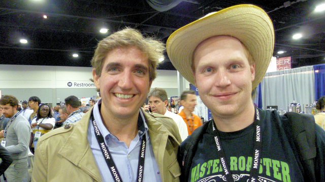 Jon Burman posing with a man at the SCAA Coffee Expo in Atlanta, Georgia