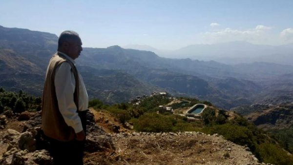 Man looking down at the Haimi landscape in Yemen