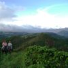 Two people riding horses on coffee estate in Huila, Colombia