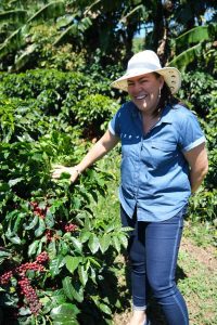 Francisca Chacon and coffee plant with red cherries