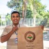 Armando holding a burlap coffee sack Timor-Leste