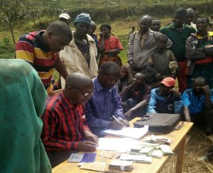 Coffee estate workers doing paperwork in Burundi
