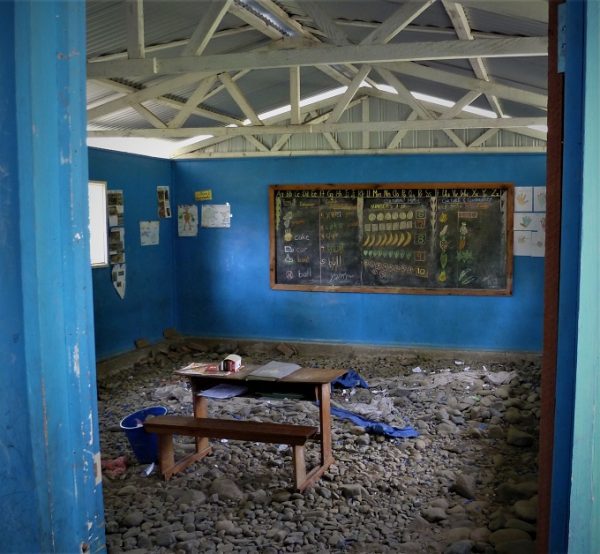A schoolhouse in Papua New Guinea with stones for flooring