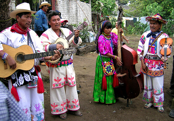 Local Mexican musicians in brightly colored traditional dress