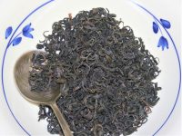 Loose leaf kenya purple tea in a bowl with a spoon