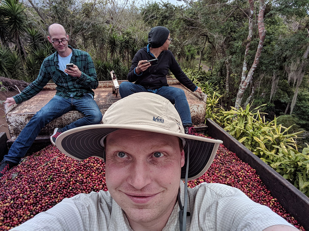 Jon Burman riding a truck filled with coffee cherries to Selva Negra in Nicaragua