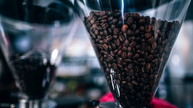 Beans in a Burr coffee grinder