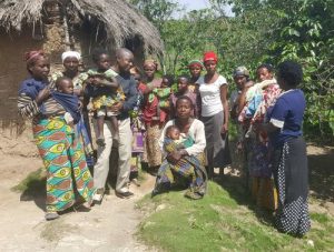 Workers and families pose outside at Coopade in Congo (DRC)