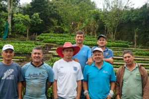 Workers posing in front of nursery with coffee saplings in Costa Rica