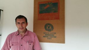 Alejandro standing next to a burlap coffee sack at Finca Huixoc, Guatamala