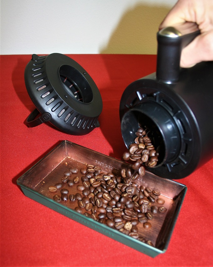 Pouring out roasted coffee beans from a Nesco Roaster