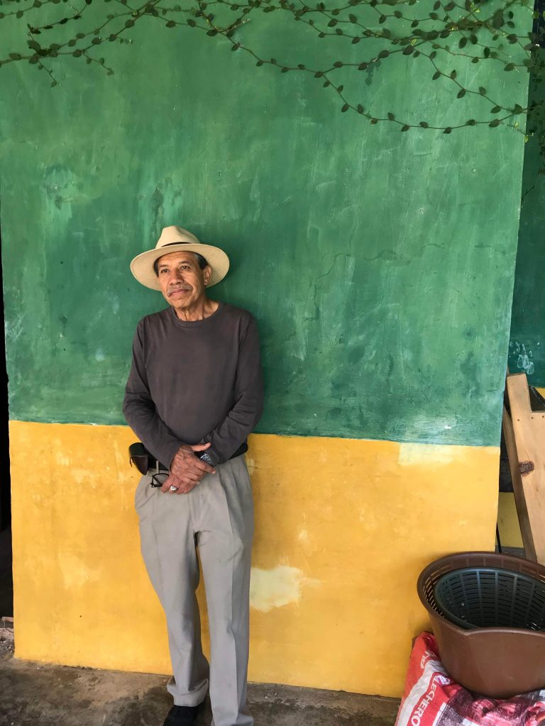 Man at finca esperanza posing in front of a wall
