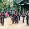 Women dancing outdoors in traditional Indonesian dress
