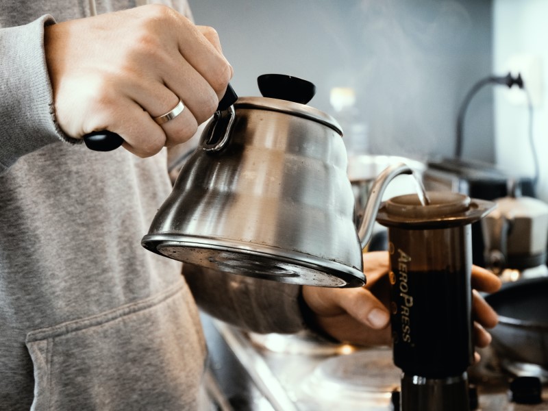 Pouring hot water in AeroPress coffee maker.