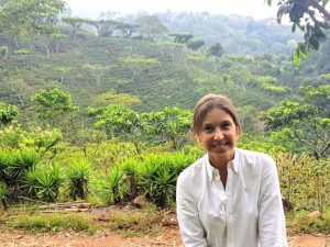 Woman in front of coffee plantation in El Salvador