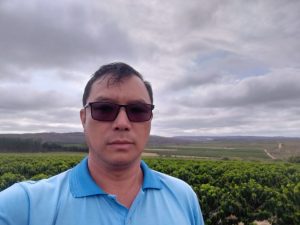 Man in front of coffee plantation