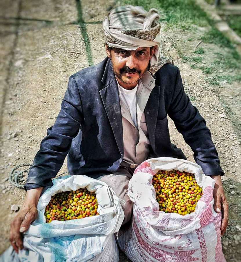 haraaz farmer with two bags of coffee cherries