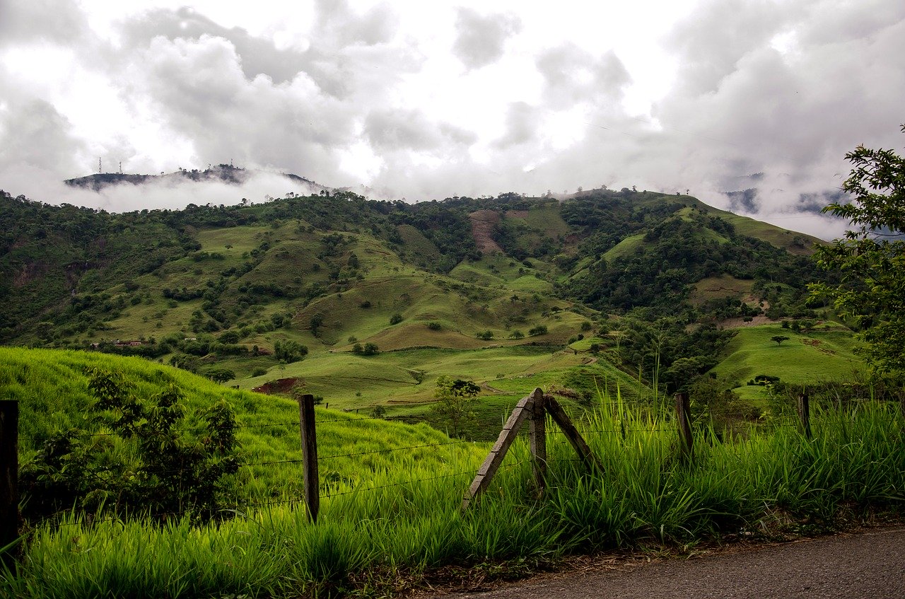landscape of rolling mountains in Colombia. The hills are verdant and lush